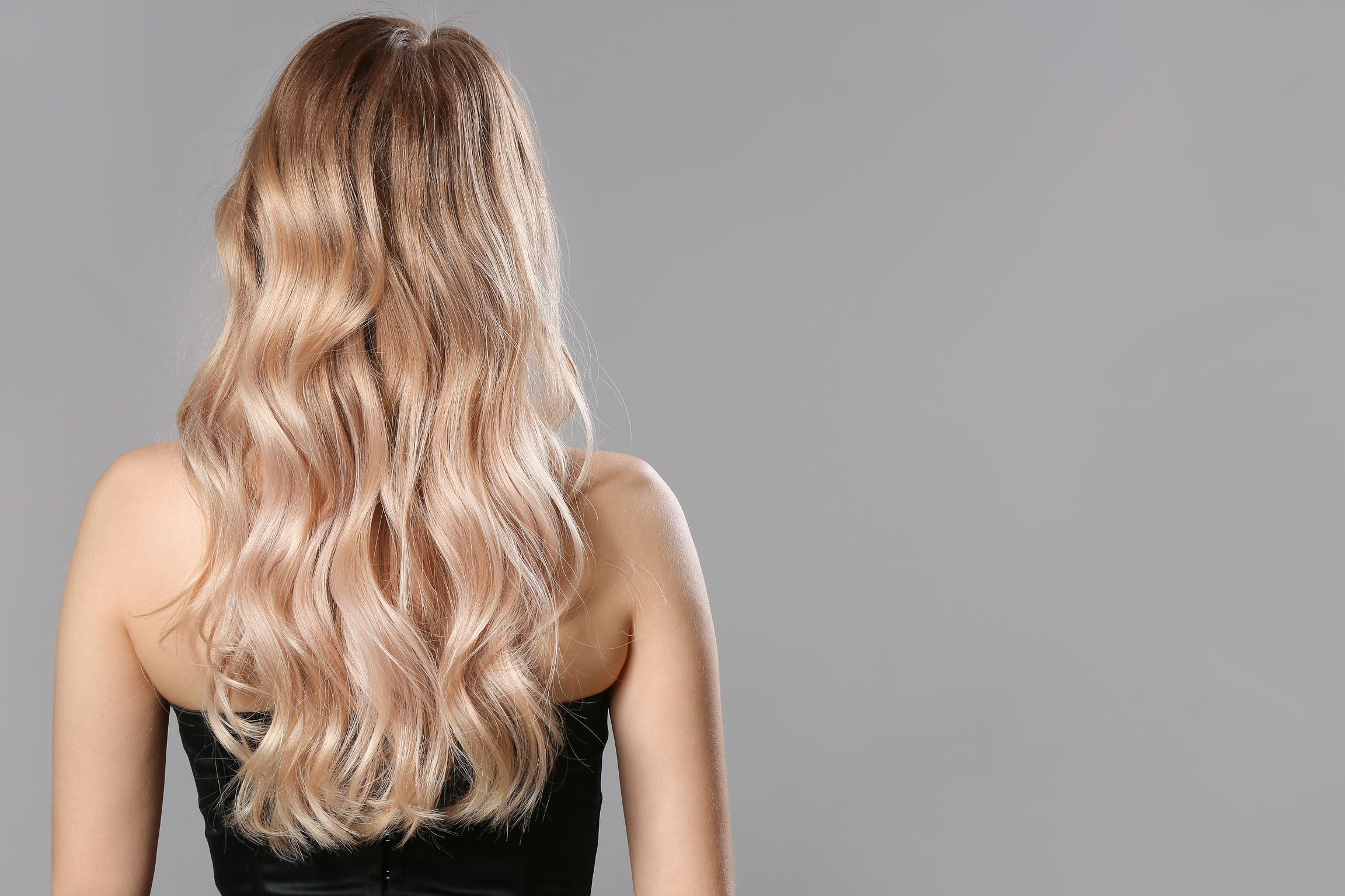 Blonde with Wavy Hair on Grey Background